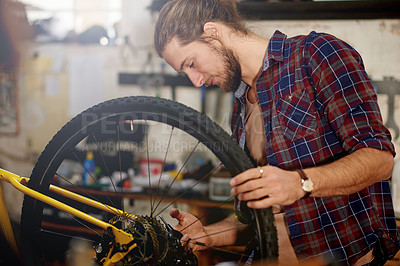 Buy stock photo Man, bike repair and gear at workshop with chain, maintenance or restoration service at garage. Person, bicycle mechanic and technician with safety check, inspection or transmission at small business
