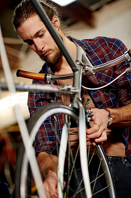 Buy stock photo Wheel, alignment or man with bicycle in garage or store for repair, maintenance or upgrade. Small business, warehouse or mechanic in workshop for bike parts, mechanical engineering or fixing tyre