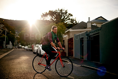 Buy stock photo Travel, adventure and man on bicycle in town for sightseeing, journey or carbon footprint on holiday. Street, cycling and person on bike for eco friendly transport on vacation in urban city at sunset