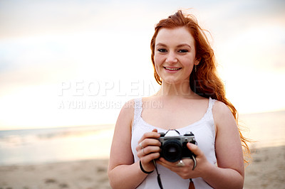 Buy stock photo Portrait, photographer and happy woman at beach at sunset for travel, vacation memory or camera. Smile, photography and girl at seashore for picture, summer holiday and space on island in Greece