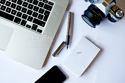 Buy stock photo Camera, notebook and laptop on desk in office for editing, research or notes for photography. Creative career, pen and top view of retouching project with equipment, computer and phone at studio.