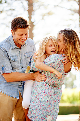 Buy stock photo Outdoor, hug and parents with girl, smile and bonding together with weekend break. Family, mother and father in park, daughter and embrace with happiness, funny and laughing with care and humor