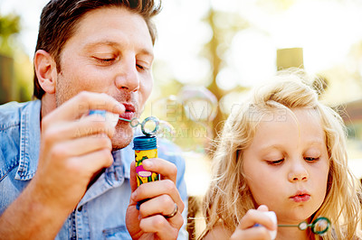 Buy stock photo Father, child and blowing bubbles outdoor for sensory play, creative imagination or bonding. Family fun, single dad and girl kid with soap toy in nature for learning activity or childhood development