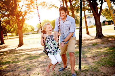 Buy stock photo Swinging, father and girl in park, smile and bonding together with happiness, game and fun. Outdoor, family and dad with daughter, weekend break and parent in playground, relax and summer holiday