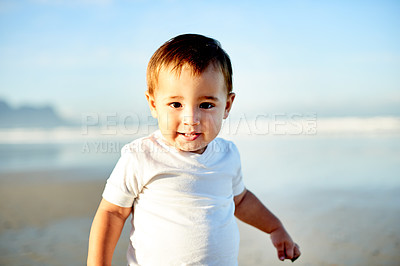 Buy stock photo Boy, toddler and portrait at beach with childhood, holiday and space outdoor for travel. Adventure, nature and smile for summer fun with male kid by ocean, games or playing with vacation in Spain