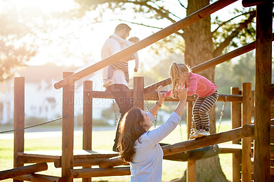 Buy stock photo Playground, happy and parents with children in park for bonding, playing games and having fun. Family, sunlight and playful mom, dad and kids outdoor for holiday, adventure and jungle gym on weekend