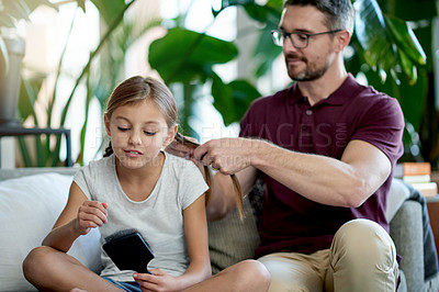 Buy stock photo Hair braid, girl and man in living room with brush, helping and support for morning routine. Bonding, daughter and single parent on couch with grooming, together and getting ready for school.