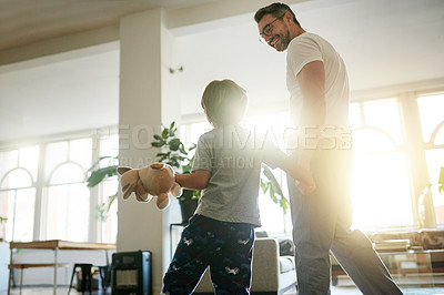 Buy stock photo Smile, father and son walking in home with hand holding for morning bonding, conversation and waking up. Love, caring man or child in lounge to support development, flare or happy for communication.