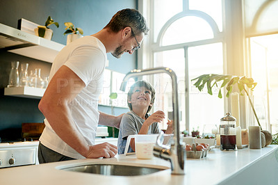 Buy stock photo Baking, help and father with child in kitchen in home with learning, fun and bonding together. Connection, flour and dad with boy kid for cooking recipe in morning for weekend hobby in house.