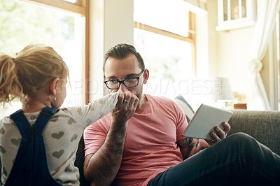 Buy stock photo Dad, kid and kiss hand for love, support and connection with girl in family home. Sofa, father and bonding with child for care, safety and daughter with parent on tablet for communication in lounge