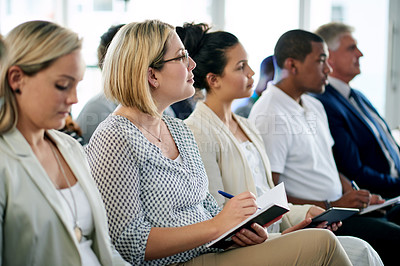 Buy stock photo Audience, business woman and notes at conference for presentation, training or attention. Seminar, convention and worker writing in notebook at company workshop for planning, insight or learning