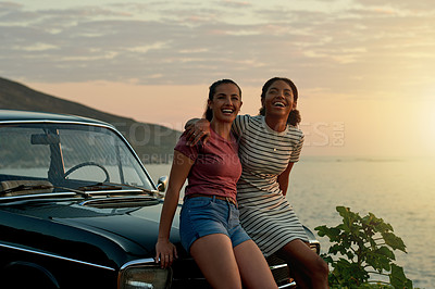 Buy stock photo Portrait of two young women enjoying a road trip