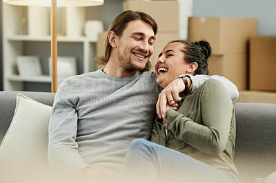 Buy stock photo Laugh, moving in and couple hug in new home for love, property investment and mortgage. Real estate, man and woman embrace in living room for relax, relocation and bonding with partner for funny joke