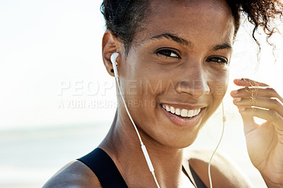 Buy stock photo Earphones, fitness and portrait of happy woman on beach for start of cardio training or workout. Face, flare and smile of African athlete or runner streaming music outdoor for exercise or health