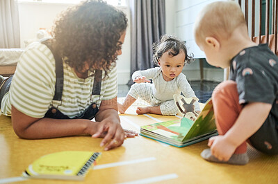 Buy stock photo Babysitter, babies and learning with book in home, storytelling and education in house. Development, care and nanny reading with children, kids or toddlers while bonding and having fun together.