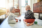 Baby play, youth and kid toys for mobility development and learning together in a bedroom. Nursery, toy brick and cute children curious about blocks game and activity in a house on the floor