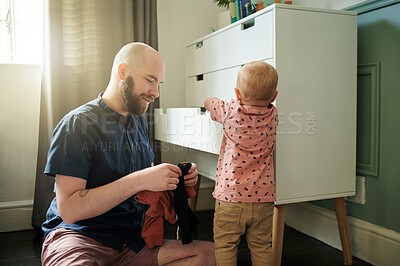Buy stock photo Getting ready, children and a father helping his son to pick an outfit from the cupboard in a bedroom. Kids, clothes and dressing with a young man teaching his toddler child about chores or packing