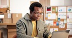Black man, laptop and research in small business for logistics, order management and feedback. Entrepreneur, smile and PC in office for inventory control, website update and distribution schedule