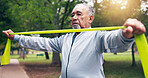 Senior, man and resistance band in park for outdoor exercise, strength workout or joint tension. Active, elderly or male person stretching with strap for muscle gain, training or physical activity