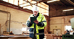 Serious, man and tablet in workshop for carpentry project specs, review fixture design or cut list. PPE, mature shopfitter and tech for CAD revision, joinery software or client email for custom order