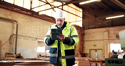 Buy stock photo Serious, man and tablet in workshop for carpentry project specs, review fixture design or cut list. PPE, mature shopfitter and tech for CAD revision, joinery software or client email for custom order