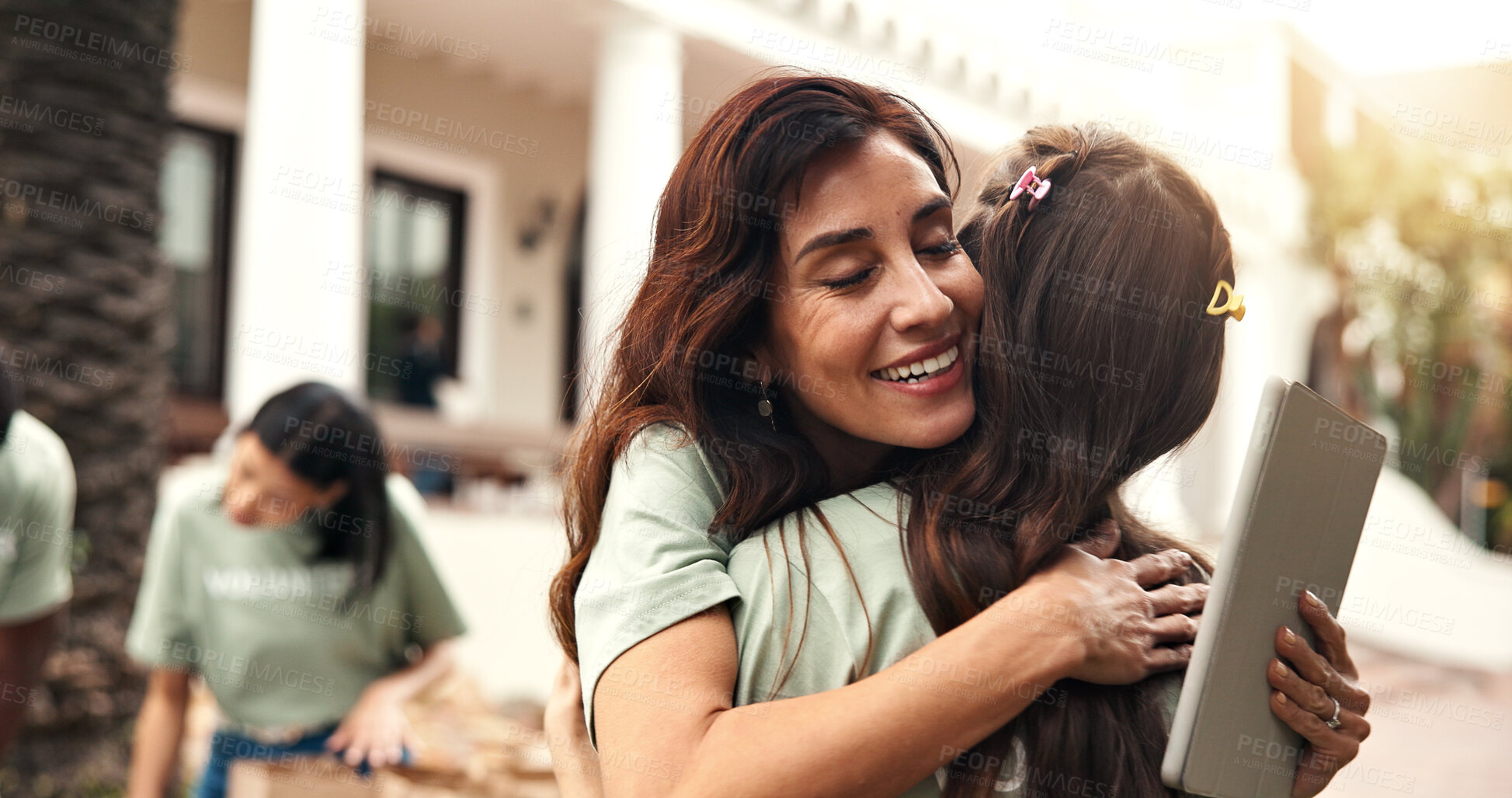 Buy stock photo Smile, people and hug outdoor for volunteering, gratitude and thank you for community service. Happy, women and embrace with tablet for appreciation, recognition and team success of welfare project