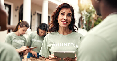 Buy stock photo Woman, team and tablet outdoor for volunteering, sign up and assign tasks for community outreach. Smile, coordinator and people with digital for charity, participation and job allocation for welfare