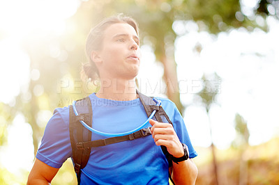 Buy stock photo Outdoor, man and exercise with running for fitness, breathing and runner with training for marathon. Nature, male person and athlete with drinking tube for wellness, endurance and cardio for workout