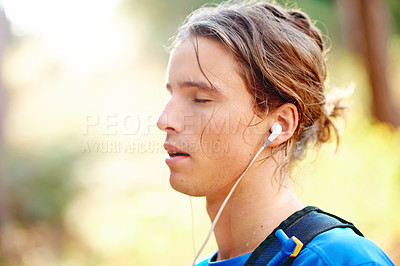 Buy stock photo Break, fitness and music with man in forest for cardio, sports training or workout routine. Earphones, exercise and sweat with tired athlete or runner outdoor in mountains for recovery or rest