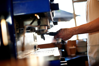 Buy stock photo Hands, waiter and portafilter at machine in cafe for coffee order, brewing process and service. Barista, man and ground beans preparation in restaurant for premium blend caffeine and fresh cappuccino