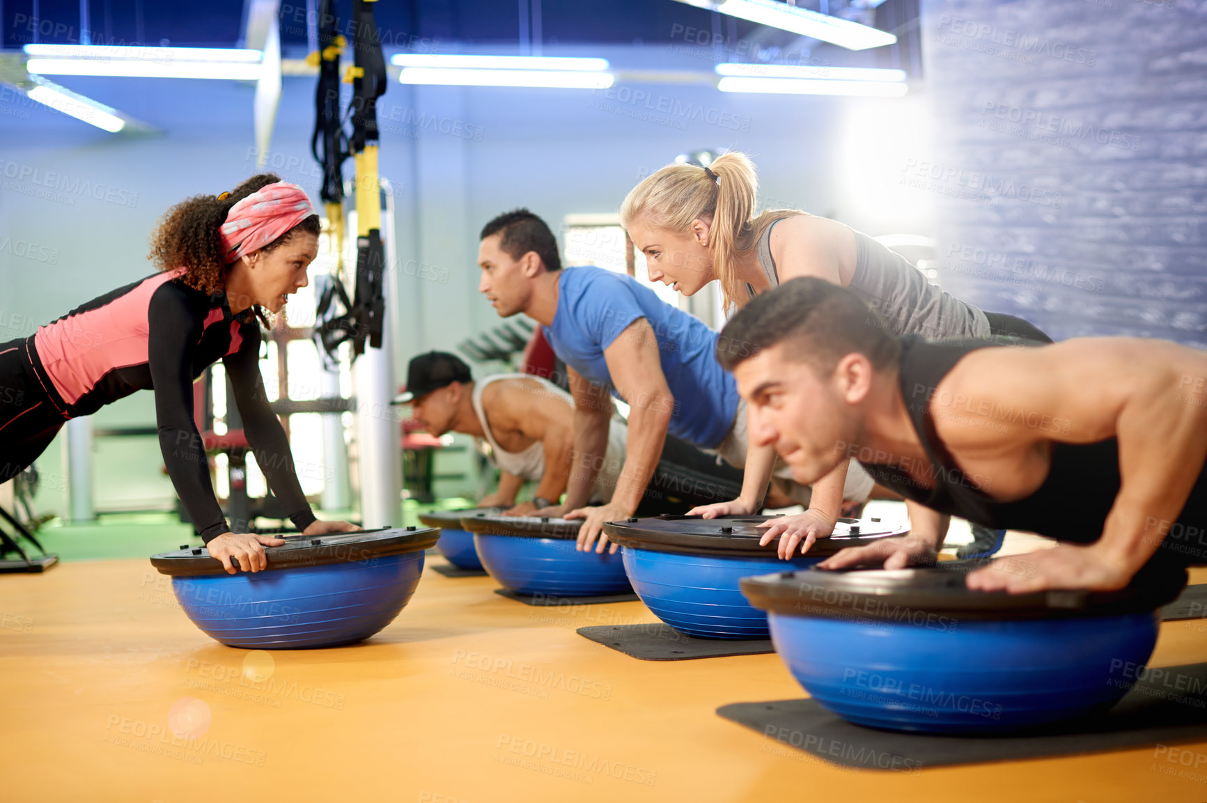 Buy stock photo Medicine ball, sport and people with personal trainer in gym for core strength workout together. Push up, equipment and athletes with health coach for balance training with wellness in fitness center