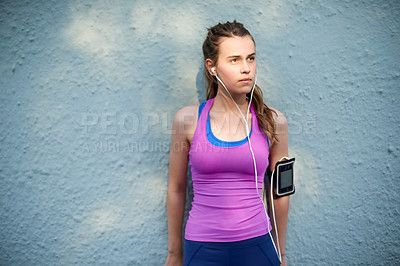 Buy stock photo Thinking, girl and earphones for fitness with wall background, listening to music and exercise ideas. Teenager, thoughts and streaming podcast for training, sports playlist and planning for running
