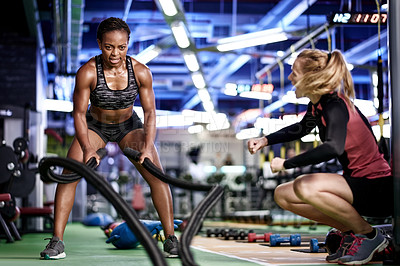 Buy stock photo Woman, coach and battle rope at gym with exercise, workout and bodybuilding performance. People, equipment and resilience with personal trainer for motivation, muscle growth and endurance challenge