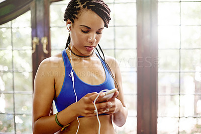 Buy stock photo Athlete, smartphone and woman with earphones, gym or listening to music on break, texting or online. Reading, message and African person with mobile for communication, streaming and tech for radio