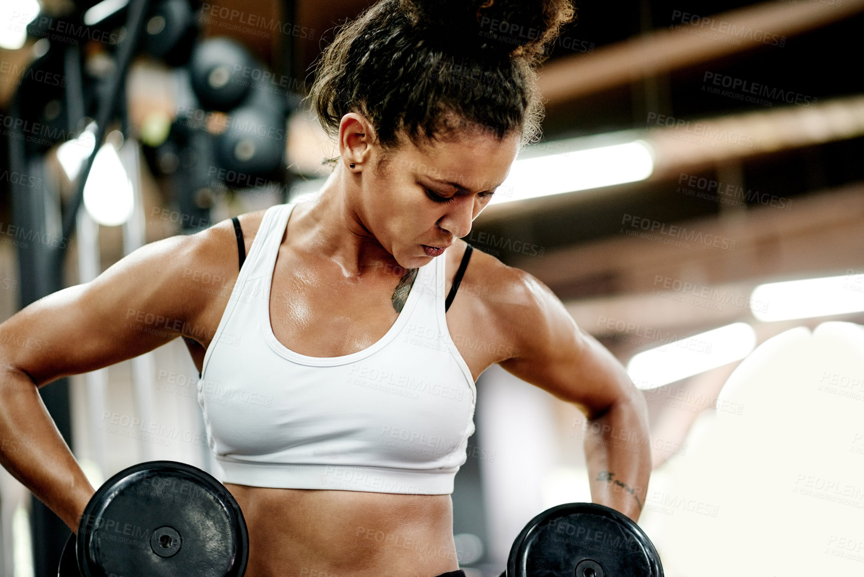Buy stock photo Exercise, woman and dumbbell for bodybuilder, workout and fitness in gym for health and power. African person, weightlifting and strong for muscle development, challenge or training for wellness