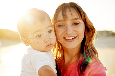 Buy stock photo Mother, baby and portrait at beach with hug, flare and love for bonding on holiday. Happy woman, boy child with embrace or holding kid outdoor, sunshine and adventure with travel in Australia