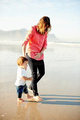 Buy stock photo Holding hands, walking and mom with child at beach for bonding, summer vacation and holiday outdoor. Family, travel and woman with toddler by ocean for fun, connection and relax together on weekend