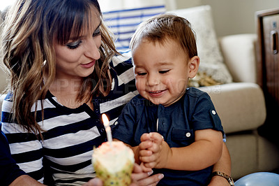 Buy stock photo Birthday, celebration or cupcake with mom and son on sofa in living room of home for milestone. Candle, growth or party with excited boy child and happy woman in apartment for bonding with cake