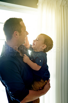 Buy stock photo Happy, playing and father with toddler in home with love, care and bonding together on weekend. Smile, family and dad holding boy kid for growth and childhood development in living room at house.