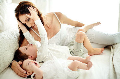 Buy stock photo Happy mom, relax and lying with children in bed for love, comfort or gentle parenting in home. Mother, kid or siblings with smile for youth development, childhood growth or bonding together in house