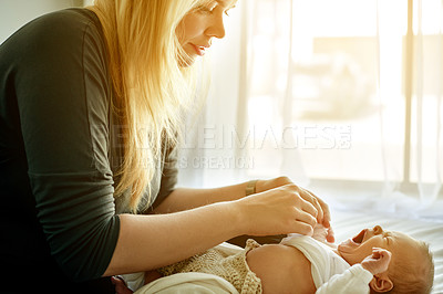 Buy stock photo Bedroom, changing and mom with baby in home for loving relationship, bonding and tired in morning. Family, house and mother with newborn yawn with clothes for care, parenting and getting dressed
