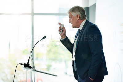 Buy stock photo Mature businessman, speech and finance convention with charts, review and stats at company. Person, leader and speaker on stage, projector and presentation with revenue announcement at conference