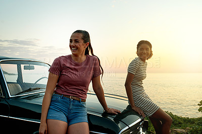 Buy stock photo Shot of two young women enjoying a road trip