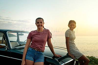 Buy stock photo Portrait of two young women enjoying a road trip