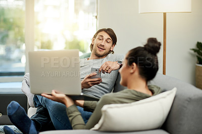 Buy stock photo Conversation, laptop and showing with couple on sofa in living room of home together for break. Computer, phone and share with happy people in apartment for connectivity, browsing or social media