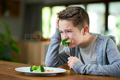 Buy stock photo Broccoli, eating and unhappy with boy at dining room table of home for diet, health or nutrition. Food, green vegetables and gross with teenage kid in apartment for lunch, organic meal or dinner