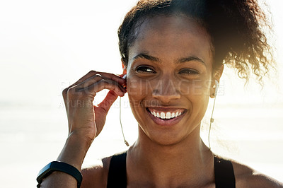Buy stock photo Girl, earphones and happy at beach for exercise, sky and space with flare for fitness routine in summer. Woman, smile and runner with audio subscription, reflection or training by ocean in Ecuador