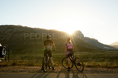 Buy stock photo Sunlight, nature and man with woman on bicycle for sports hobby, outdoor exercise and workout. Mountain, lens flare and back of couple on bike in countryside for adventure, wellness and fitness