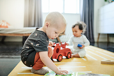 Buy stock photo Baby playing, home and kids book for mobility development and creative learning in a bedroom. Nursery, toys and cute children curious about build play game and activity in a house on the floor