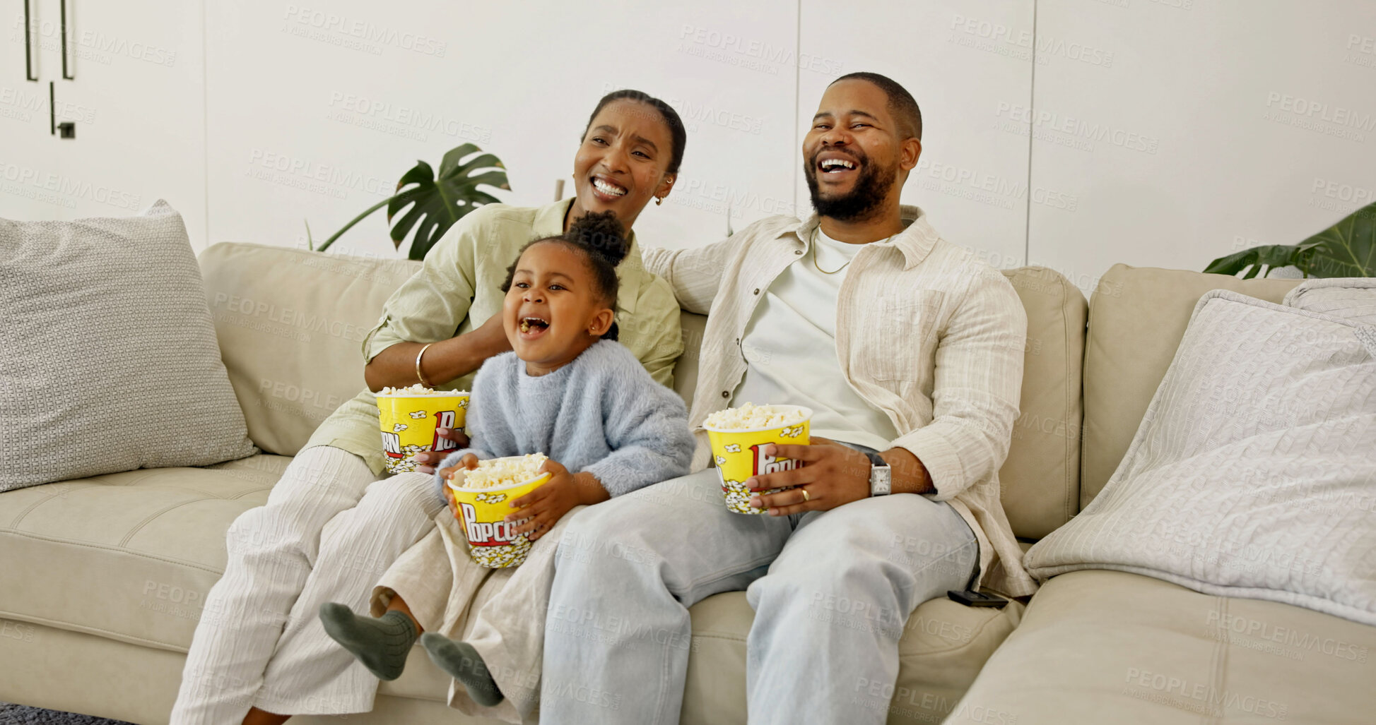 Buy stock photo Family, laughing and watching tv with popcorn in home for entertainment or online streaming on sofa. Mom, dad or child eating with smile for comedy movie, subscription or humor together in house